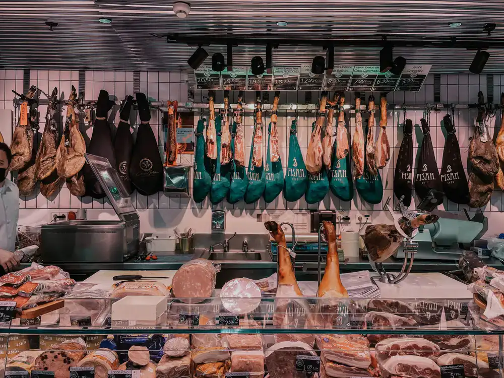 Gourmet deli counter displaying various meats and cheeses